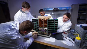 Engineers and scientists complete the installation of the laser heterodyne radiometer (LHR) into the MiniCarb cube satellite.
