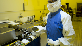 Engineer Vanessa Tolosa holds up a silicon wafer