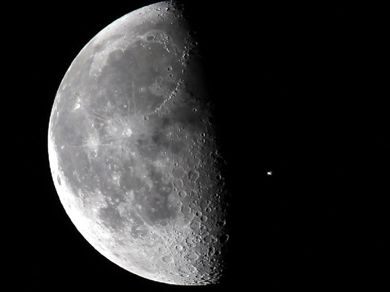 International Space Station passing in front of moon