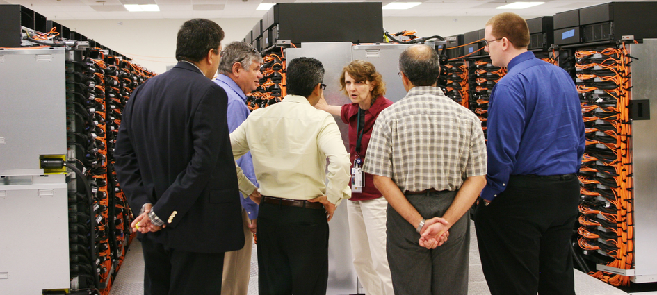 Terri Quinn showing supercomputer to visitors
