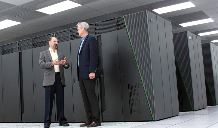 Computer Scientist and CIO standing in front of supercomputer