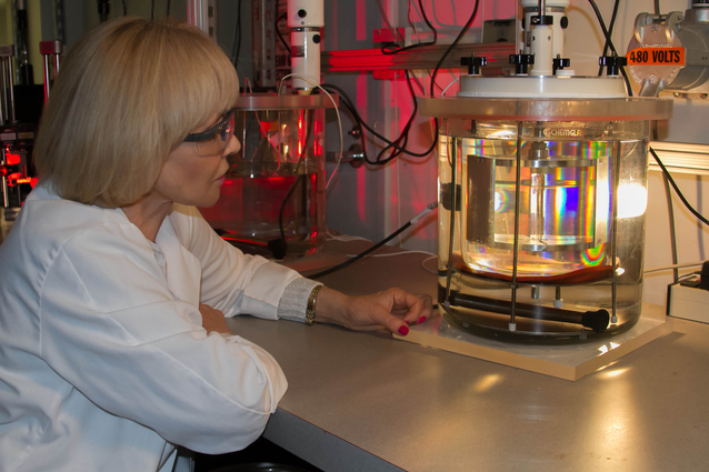 Physicist Natalia Zaitseva examines a single crystal growing in a solution-growth crystallizer