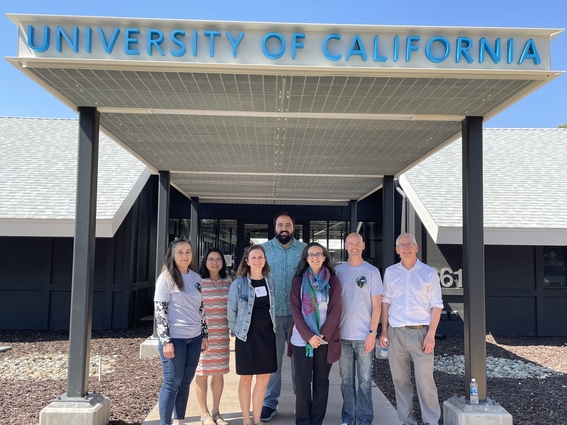 A group of students with LLNL leadership in front of the University of California Livermore Collaboration Center