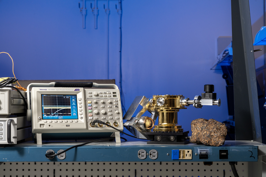 Two scientific instruments and a meteorite sample, side-by-side